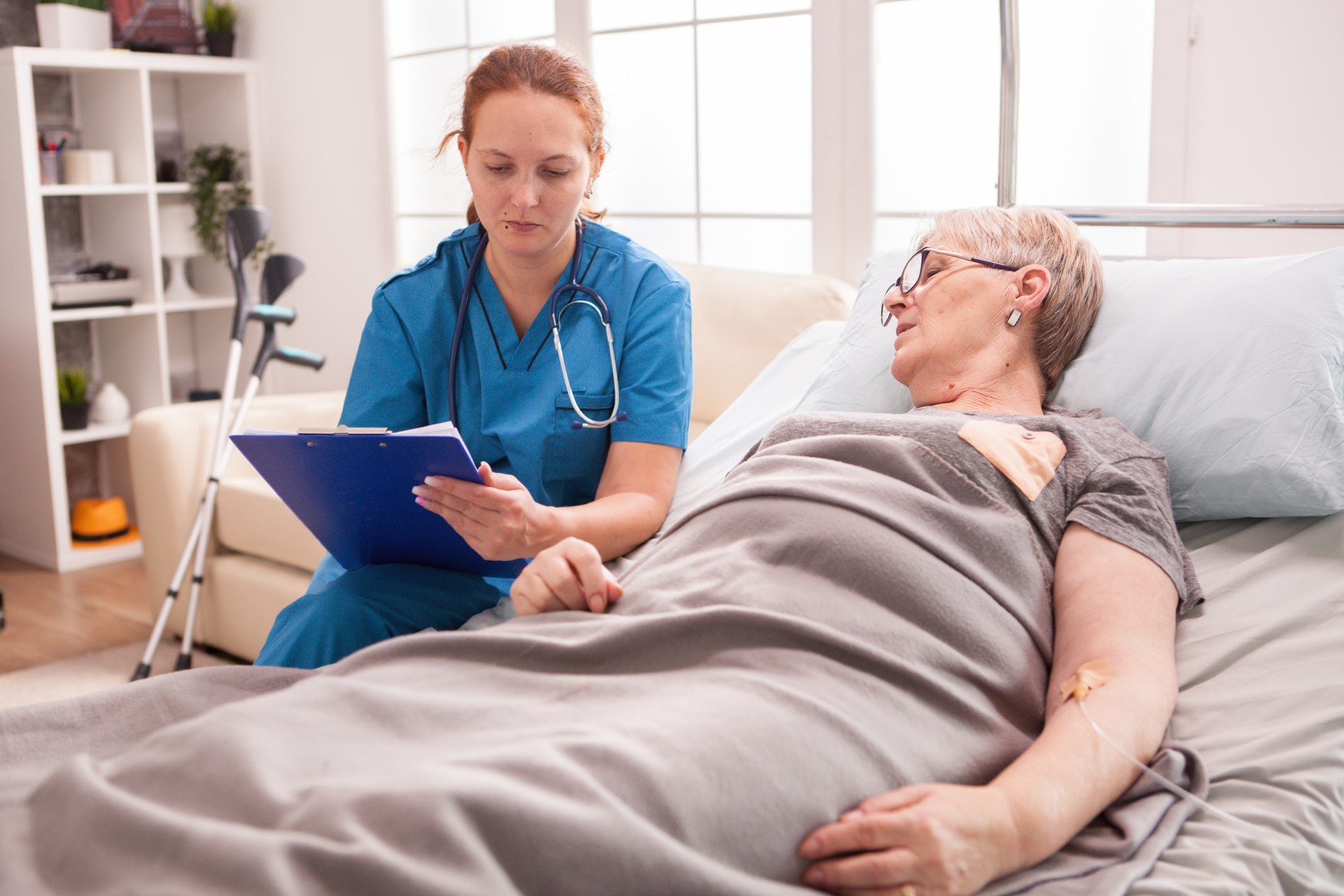 Female psychologist talking with senior woman in nursing home.